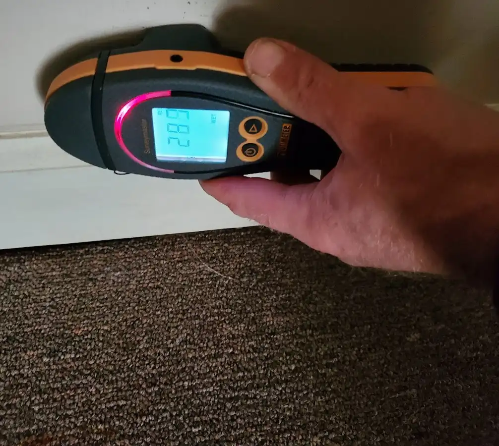 Moisture detection at baseboard during Storm Damage Restoration in Hope